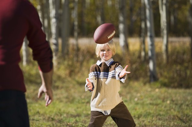 Father and son playing football