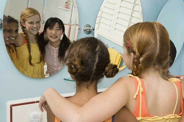 Three friends looking in mirror