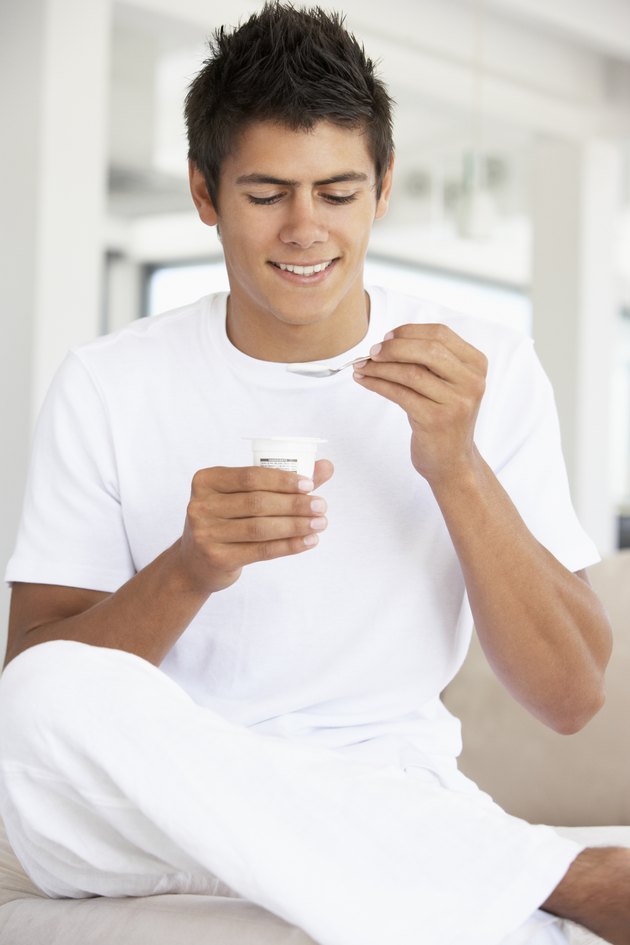 Young Man Eating Yogurt