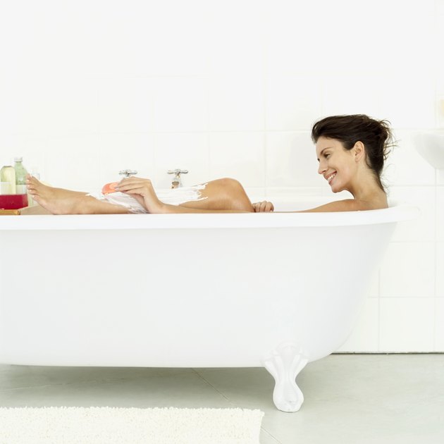 woman shaving her legs