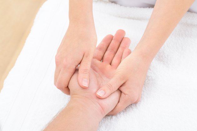 Physiotherapist Massaging Palm