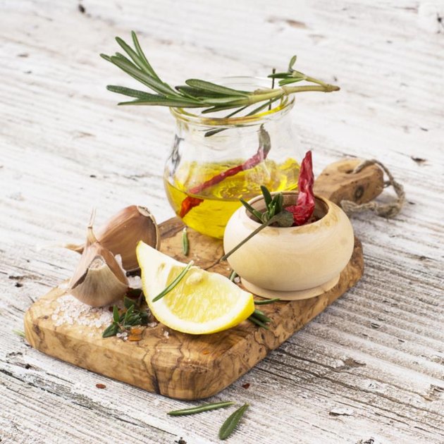 The ingredients for marinating meat before baking or grilled skewers for easy summer family picnic lunch. Olive oil, balsamic, soy, garlic, salt, pepper, rosemary, lemon marinade. selective Focus