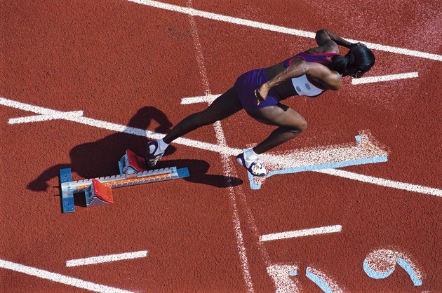 Female runner leaving starting blocks
