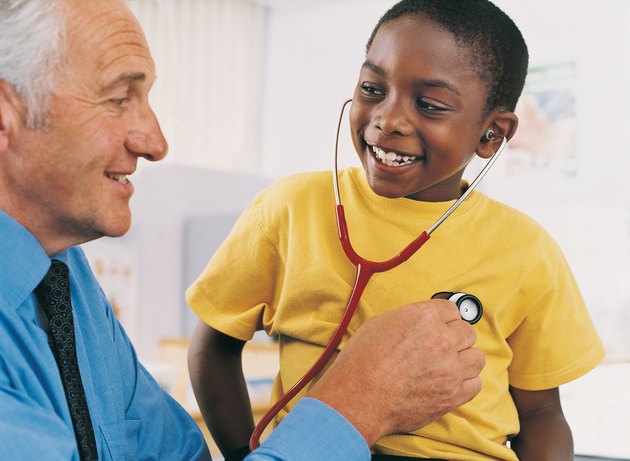 Doctor Explaining Stethoscopes to Boy