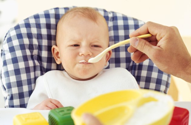 Close-up of father feeding baby boy (6-12 months)