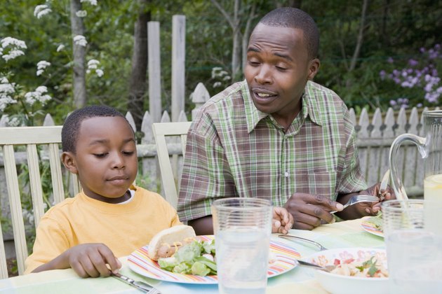 Mid adult man and his son having breakfast