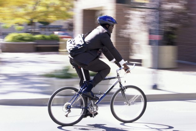 Side profile of a businessman riding a bicycle