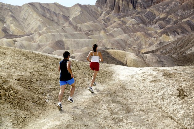 Man and woman running in desert
