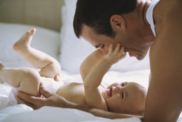 Side profile of a father playing with his daughter