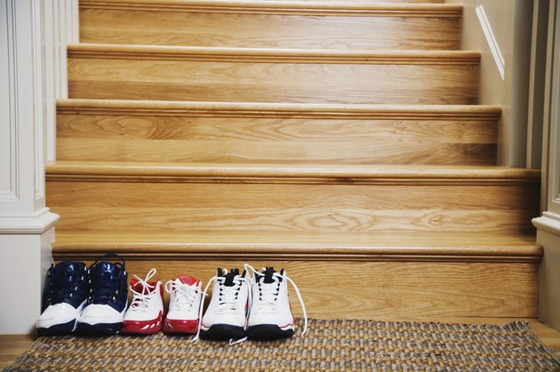 Sneakers lined up at bottom of stairs