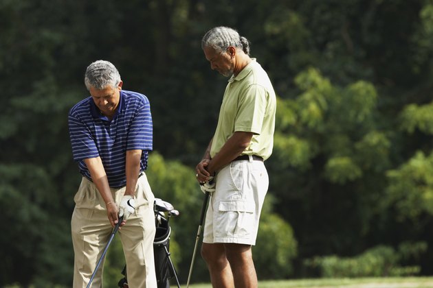 Multi-ethnic men playing golf