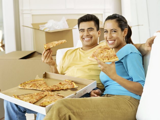 portrait of a young couple eating pizza