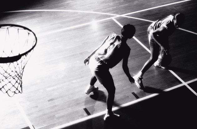 High angle view of two young women playing basketball