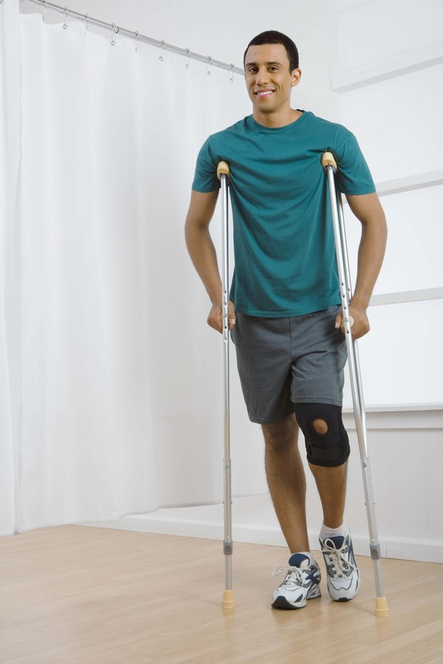 Man with knee brace and crutches