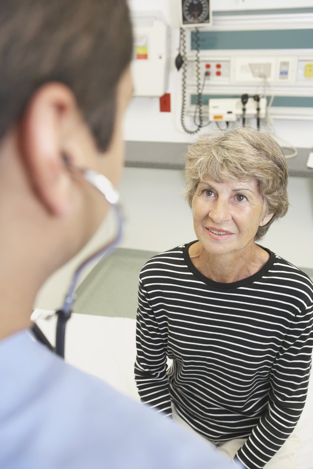 Senior woman talking to doctor in hospital