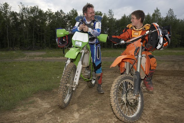 Father and son on off-road motorbikes
