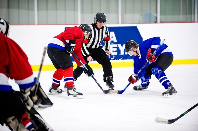 Men playing ice hockey