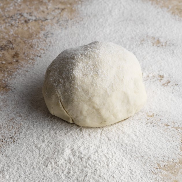 Ball of dough on floured countertop