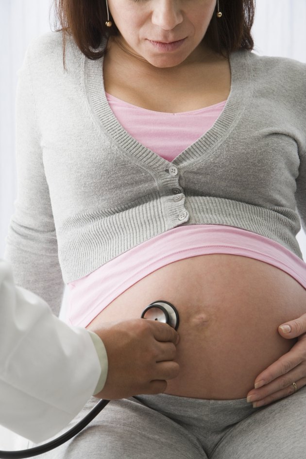 Doctor examining pregnant woman