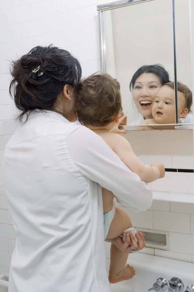 Mother and son looking in mirror