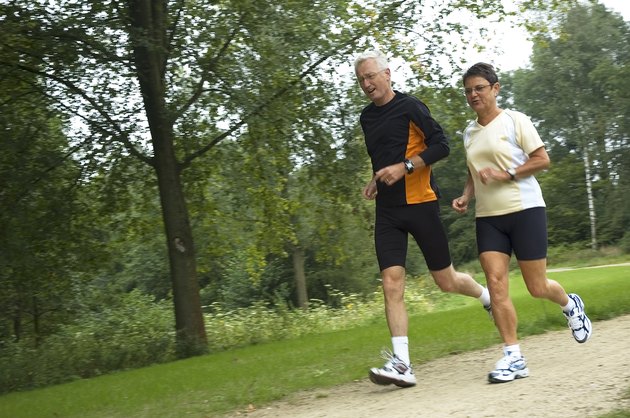 Senior Couple Running In The Woods