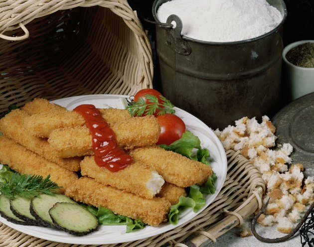 Fried fish sticks with sauce in a plate