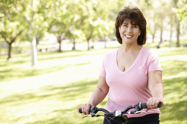 Senior Hispanic woman with bike