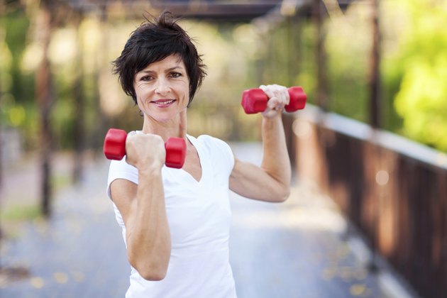 middle aged woman workout with dumbbells