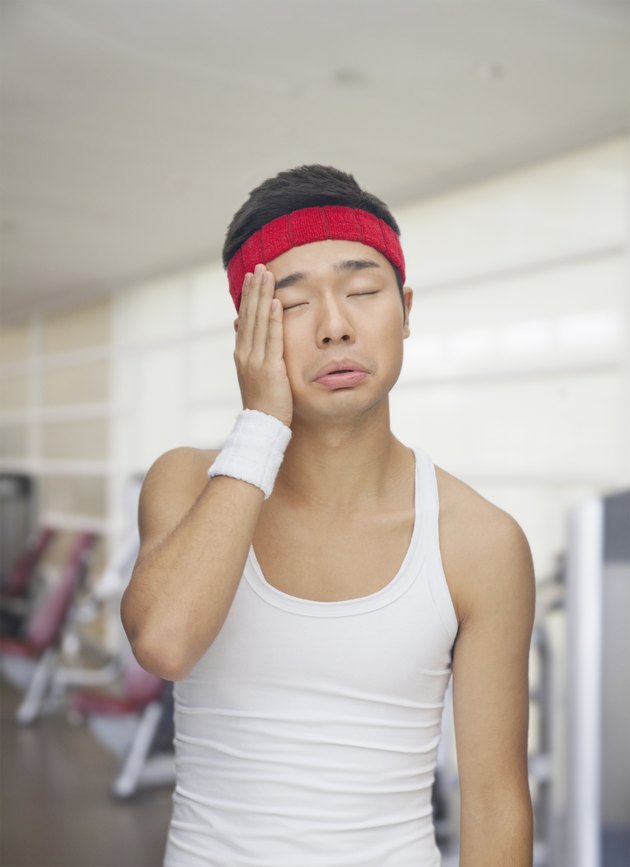 Portrait of tired young man at the gym