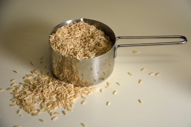 Brown rice in measuring cup