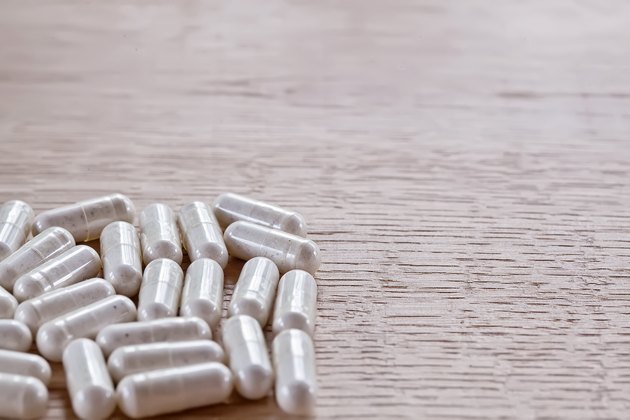 Capsules on a wooden surface