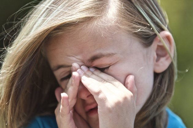 Child rubbing face