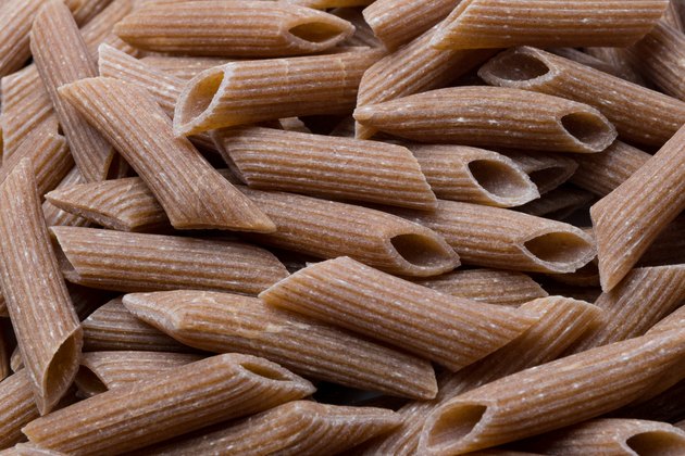 Raw brown pasta - background food concept