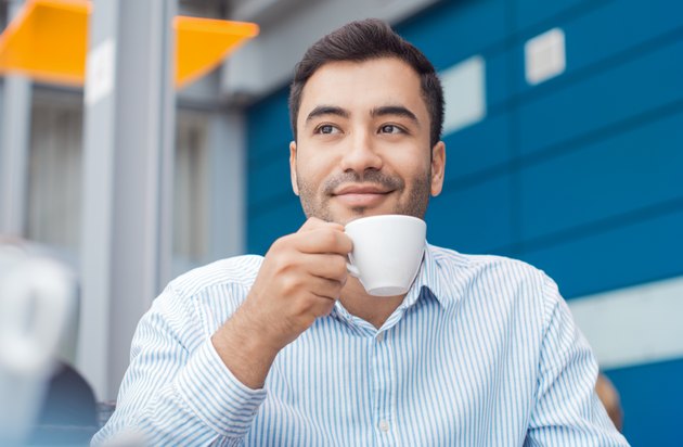 Coffee break, man resting with warmly drink