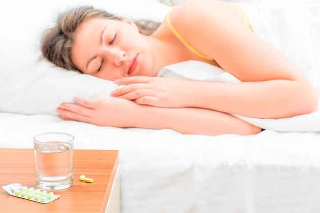 pills and a glass of water for the sick girl
