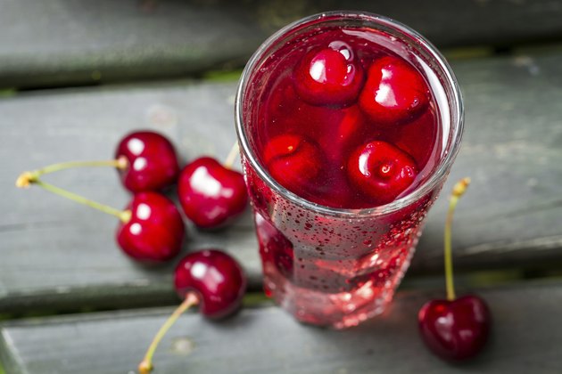 Closeup of fresh juice with sweet cherries and ice