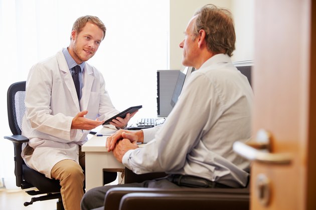 Male Patient Having Consultation With Doctor In Office