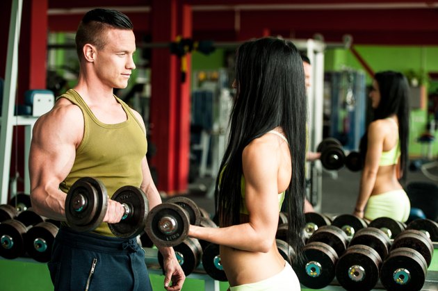 Fitness couple workout fit man and woman train in gym