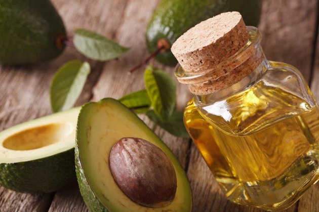 avocado oil in a glass bottle on a table close-up. Horizontal