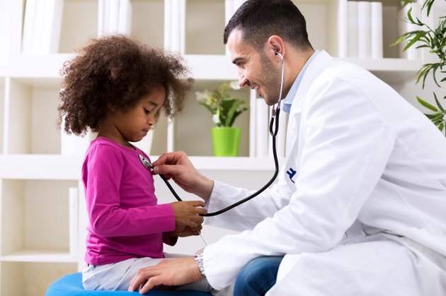 Pediatrician and little girl at hospital.
