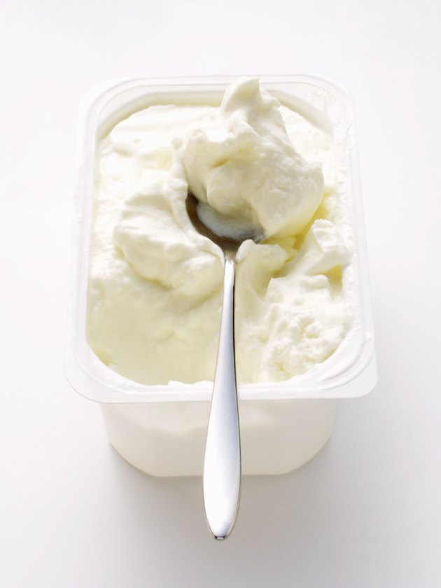 Cottage cheese in white bowl with spoon