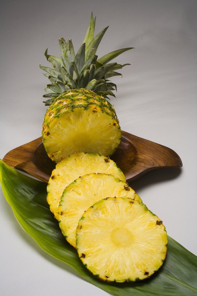 Studio shot of a pineapple, cut into slices.