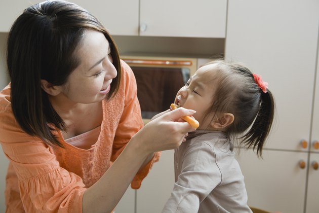 Mother Brushing Daughter's Teeth