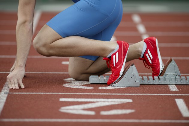 Detailed view of a sprinter in the starting blocks