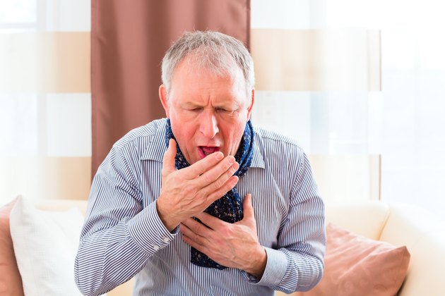 Senior coughing and having the flu