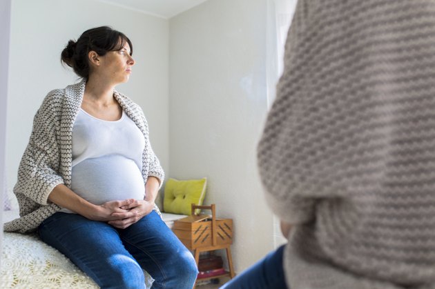 Pregnant woman reflected on a mirror