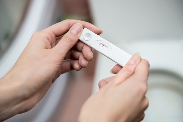 woman honding negative pregnancy test