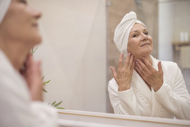 Attractive senior woman browsing in the mirror