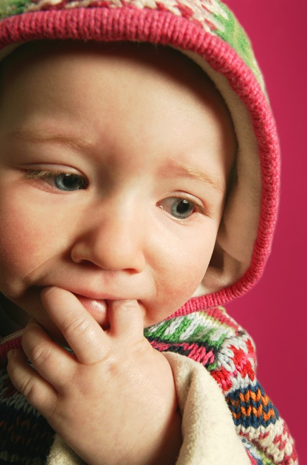A baby with fingers in mouth