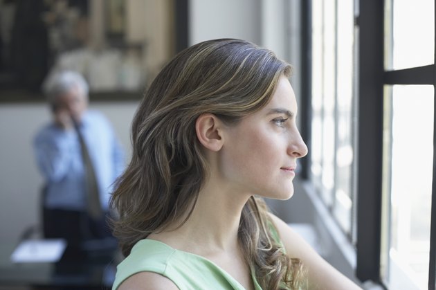 Side profile of a businesswoman looking through a window